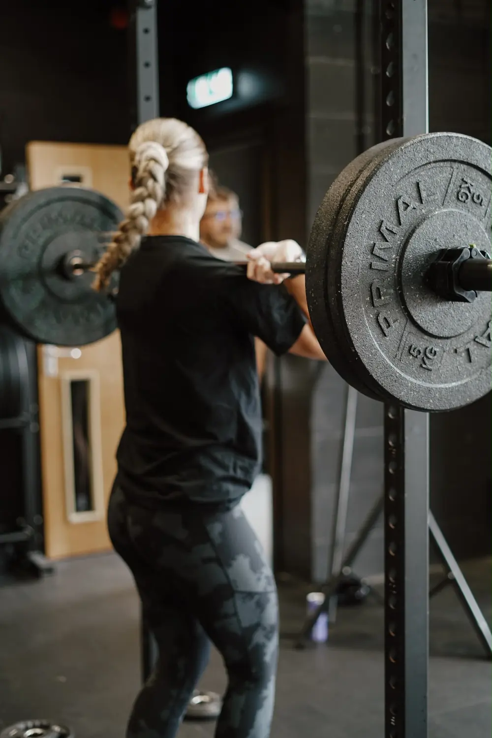 Member front squatting in the rack