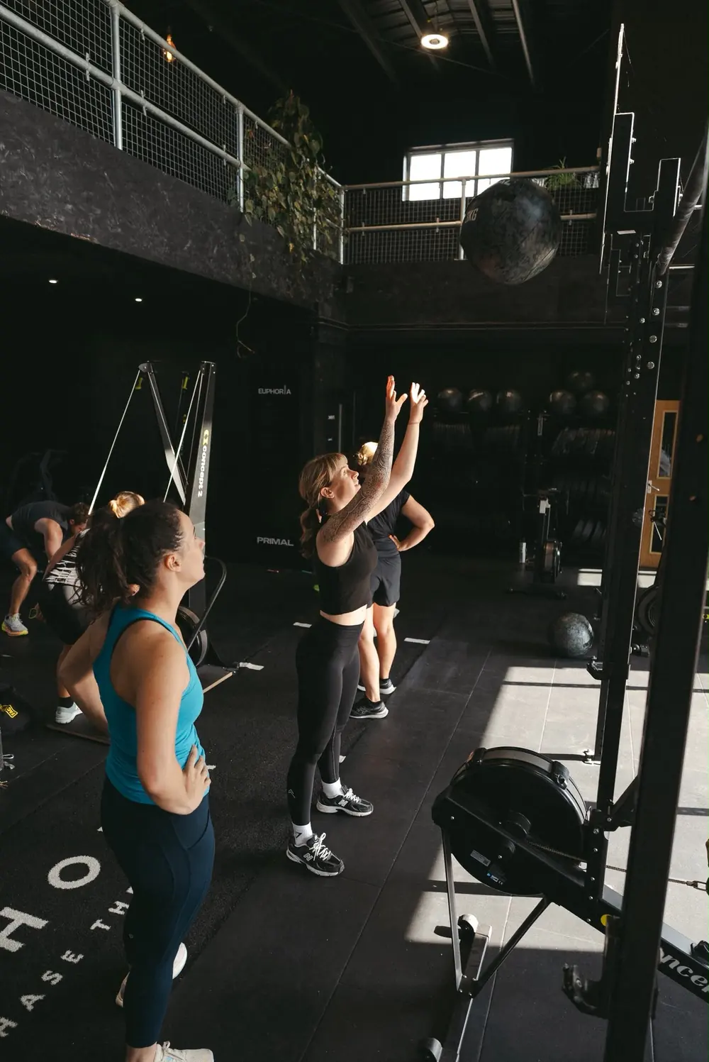 Members throwing wall balls side by side