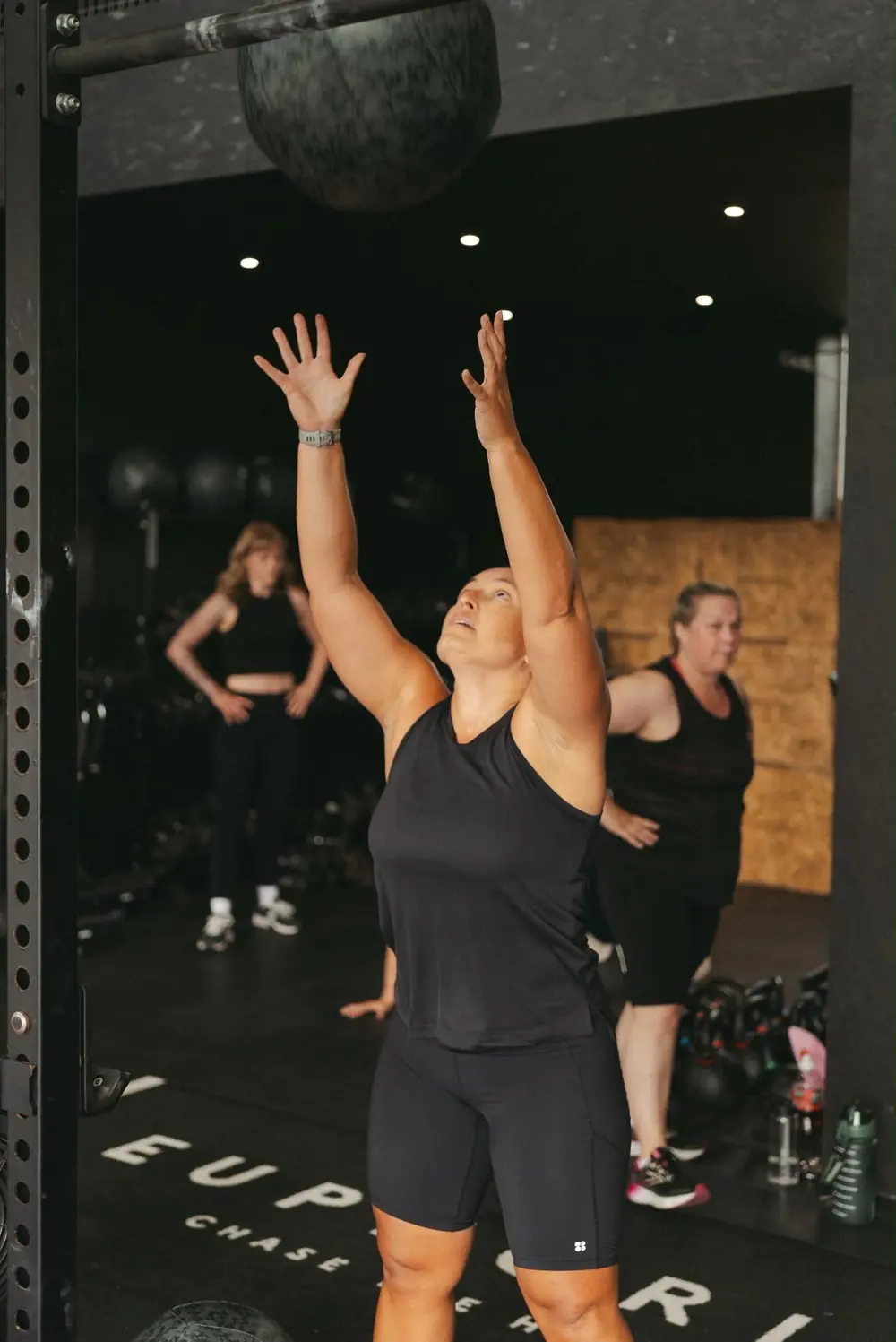 Member throwing a wall ball to the target